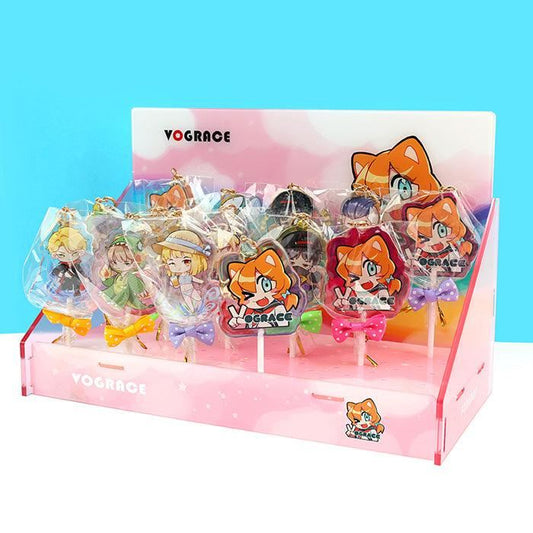 Custom acrylic lollipop charms with anime characters, displayed in a pink stand with bows